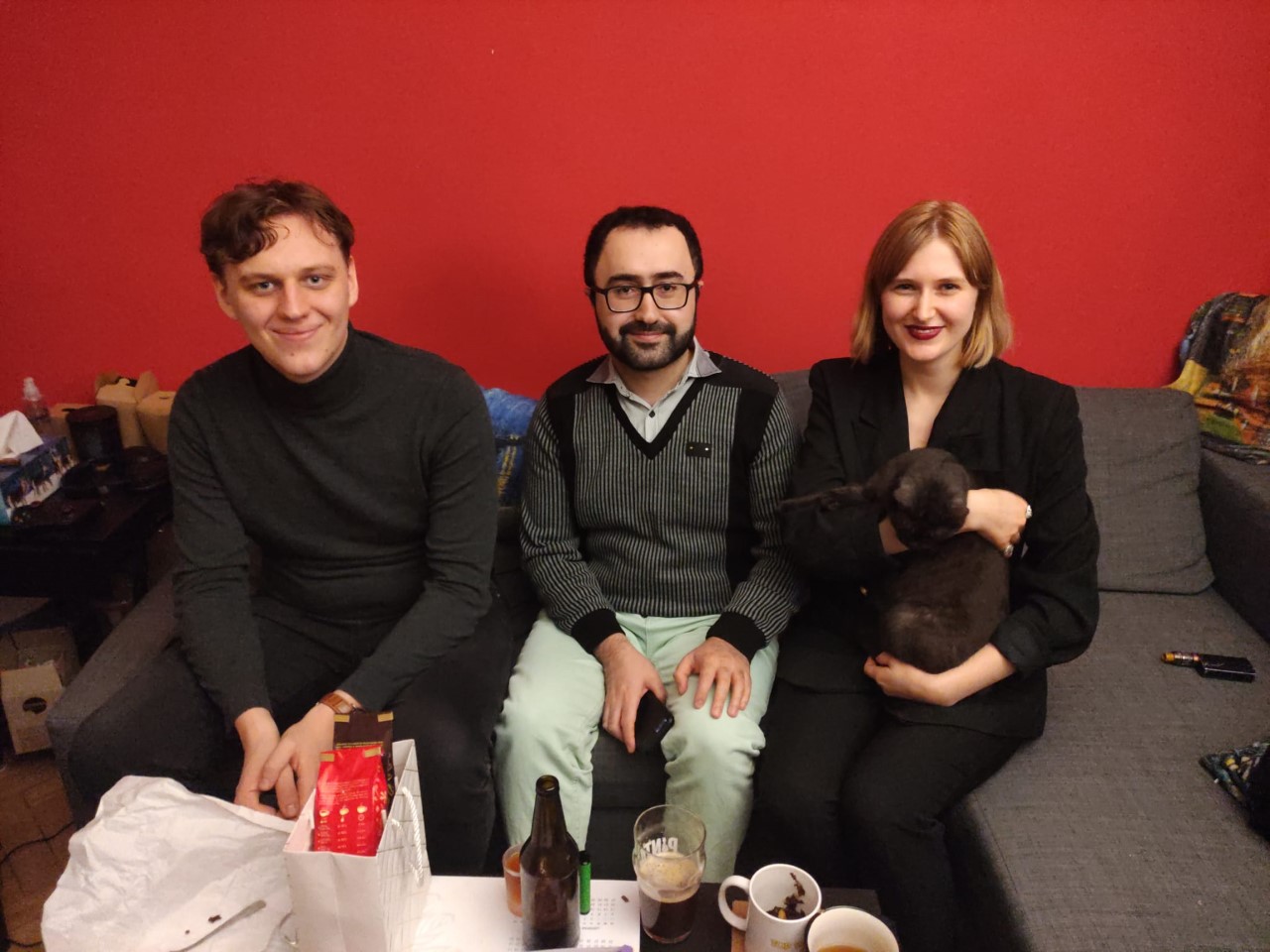 Participants of the University of Lodz "Christmas Guest" campaign, two smiling men and a woman