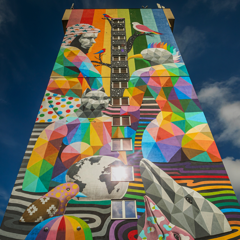 A multi-coloured mural covering the entire facade of one of the dormitories of the University of Lodz