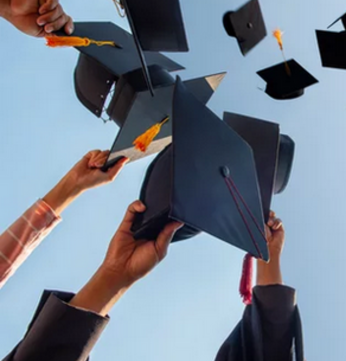 Absolwenci podrzucają birety