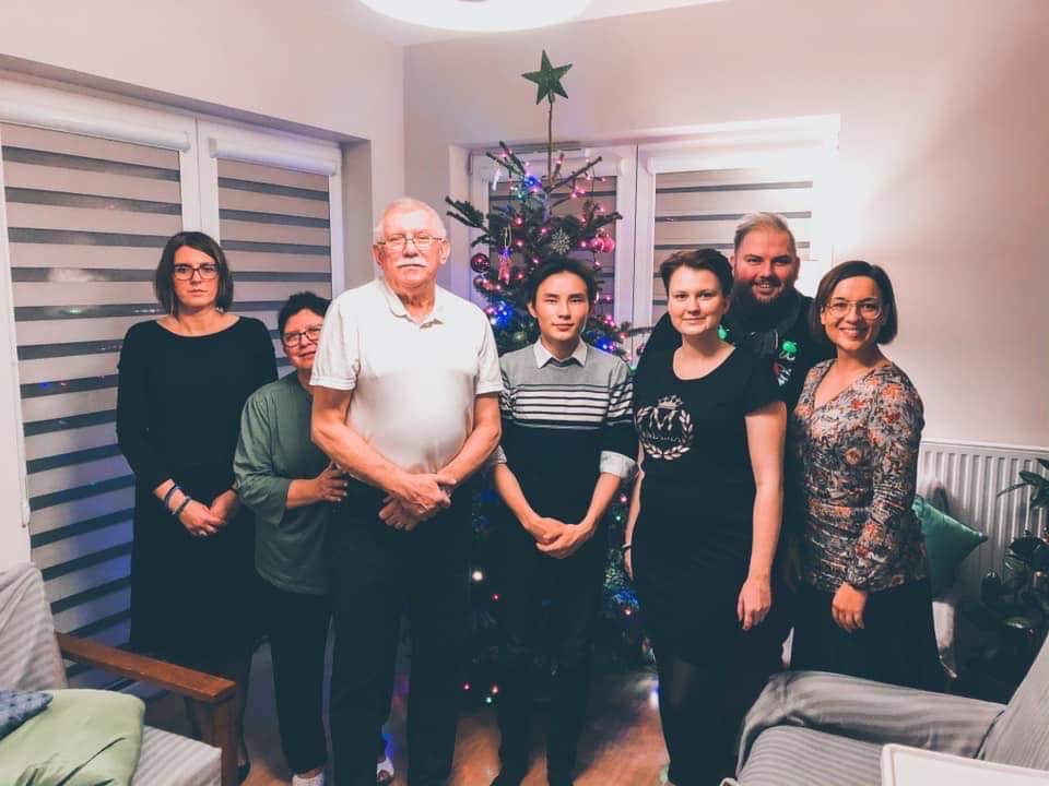 a group photo of a family taking part in the campaign with their international guests